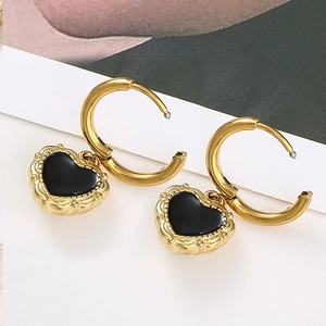 Baroque vintage gold hoop earrings featuring black heart charms with embossed texture
