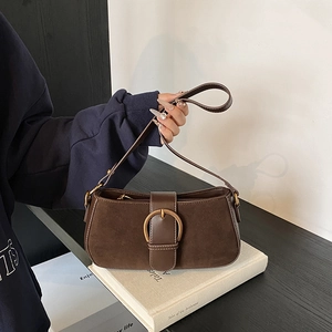 Brown suede underarm bag with large gold buckle and vintage shoulder strap design