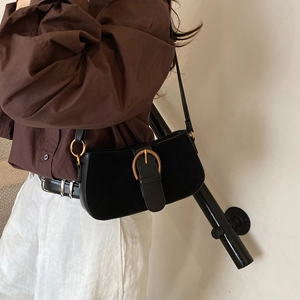 Retro black suede underarm bag with large gold buckle and half-moon silhouette