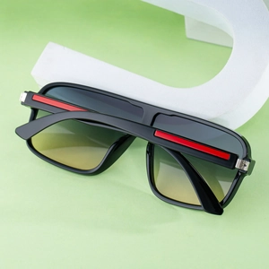 Detail of square frame sunglasses showing red accents and gradient lenses on props