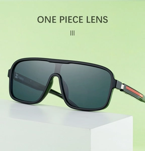 Detail view of one-piece lens sunglasses with red accent on the black frame