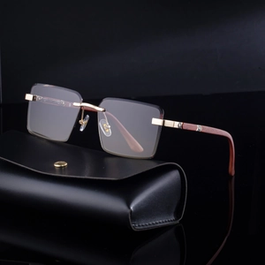 Frameless square sunglasses with gold hinges and wood grain temples on a leather case
