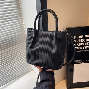 Modern black pleated bucket bag with dual handles and slim shoulder strap for women