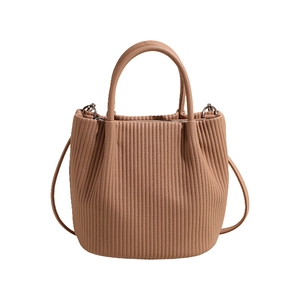 Brown pleated bucket bag with vertical textured leather and adjustable crossbody strap