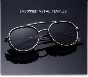 Detailed macro view of embossed metal temples and double bridge on gold sunglasses