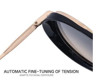 Macro detail of flexible metal hinges and ribbed gold temples on retro sunglasses