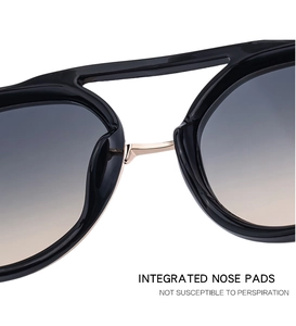 Detail of integrated nose pads on vintage sunglasses with gradient lenses and gold bridge