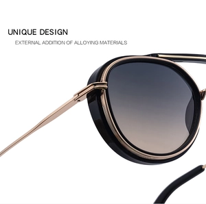 Close-up of black and gold alloy frame vintage sunglasses with gradient lenses