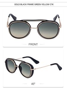Detail view of gold and black punk sunglasses with gradient green lenses, color code C7K