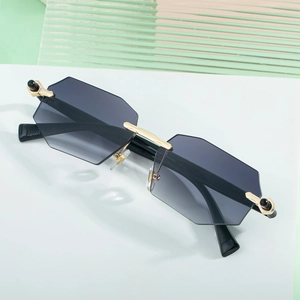 Modern rimless polygon sunglasses with grey gradient lenses and gold metal frame
