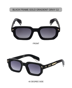 Detail view of square black frame sunglasses with gold temple accents and gradient gray lenses