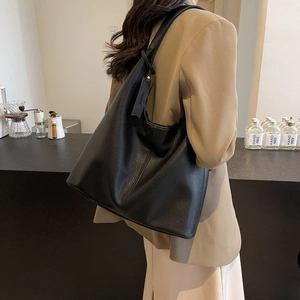 Minimalist black pebbled leather large tote bag for women showing spacious hobo design