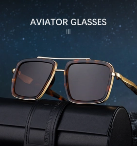 Detail of aviator sunglasses with gold metal frame and tortoise shell trim on leather case