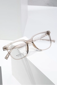 Macro detail of transparent tea-colored square frames showing model AT68606 and specifications