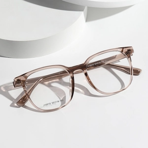 Men's rectangular transparent tea-colored optical glasses frames on white pedestal