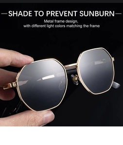 Detail of golden metal frame sunglasses with octagonal design and dark sun lenses