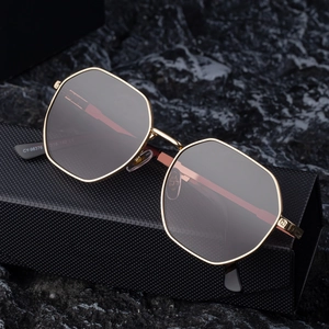 Fashionable square metal frame sunglasses with dark grey gradient lenses on a case