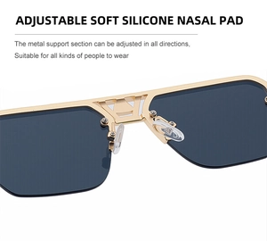Detail of adjustable soft silicone nose pads on semi-rimless gold metal sunglasses
