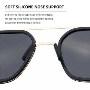Detail of adjustable soft silicone nose pads on black and gold pilot sunglasses