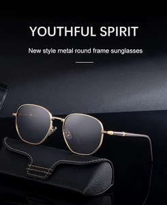 Detail of gold metal square frame sunglasses with textured textured edges and dark lenses