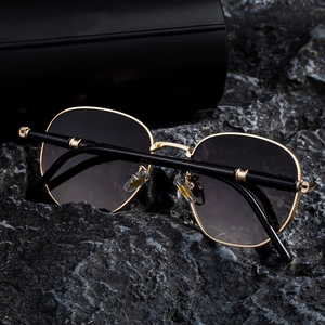 Detail of square gold metal frames and gradient lenses on luxury fashion sunglasses