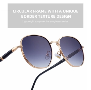 Detail of square sunglasses with gold metal frame, purple gradient lens and frame texture