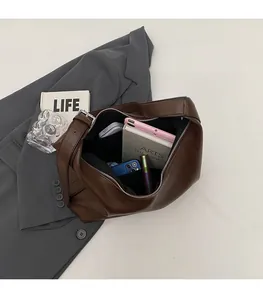 Interior view of large capacity dark brown tote bag showing storage of daily essentials