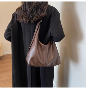 Close-up of the vintage brown hobo bag featuring soft textured synthetic leather material
