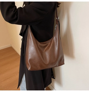 Retro dark brown Hobo bag shown with professional black blazer for commuting style