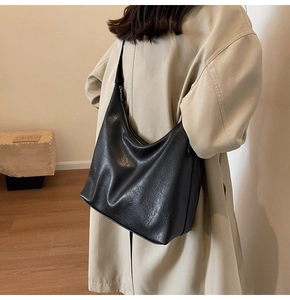 Detailed back view of a large black tote bag on model for commuter daily style