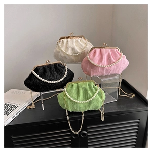 Detail of vintage lace handbags with pearl handles and metal chains in four elegant colors