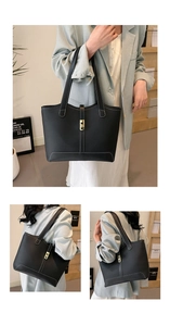 Detail of black pebbled leather tote bag with white stitching and gold hardware buckle
