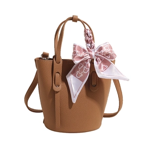 Brown lychee leather bucket bag with floral silk scarf detail and crossbody strap