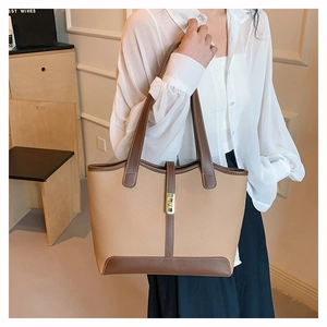 Detailed view of the contrast color leather tote bag with elegant metallic clasp and stitching
