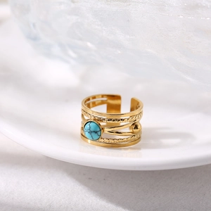 Gold multi-layer titanium steel open ring with green turquoise stone in white ceramic tray
