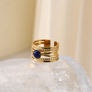Golden multi-layer titanium steel open ring with a round blue gemstone on a crystal base