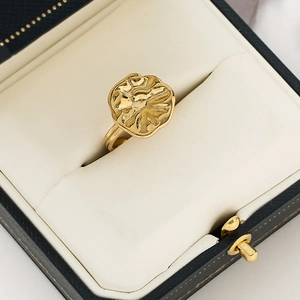 Macro detail of 18k gold plated hammered texture open ring in a premium blue jewelry box