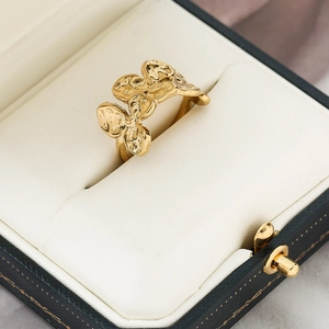 Detailed macro shot of 18k gold irregular flower ring with hammered lava texture