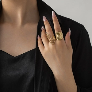 Detailed close-up of French vintage gold-plated steel rings with textured hollow design