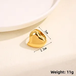 Close-up of polished gold heart ring showing dimensions 2.2cm width and 11g weight