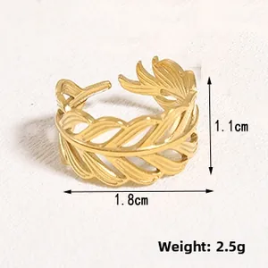 Macro shot of gold leaf textured open ring showing detailed cut-out feather design