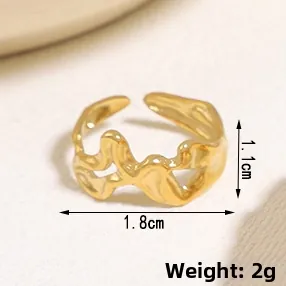 Detail view of gold wavy hollow ring with 1.1cm height and 1.8cm diameter specs