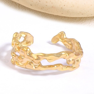 Detailed top view of irregular hollow gold ring featuring a unique lava flow texture
