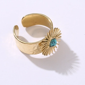 Detailed macro view of retro sunflower steel ring with blue turquoise and hammered texture