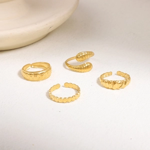 Irregular geometric gold rings set featuring star engraving and twisted band design