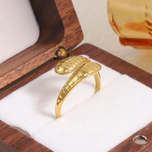 Detailed macro view of a gold-plated irregular snake-head ring on a velvet jewelry box