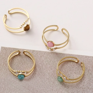 Detail of bohemian gold-plated double-layer rings with natural stone and zircon inlay