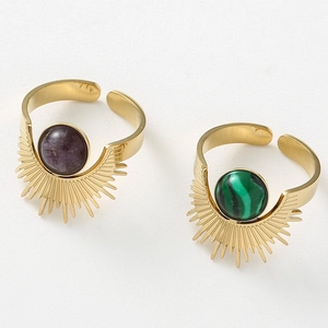Detail of adjustable gold sunflower rings with purple and green natural stones
