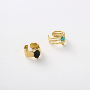 Gold plated stainless steel rings featuring black teardrop and turquoise square stones