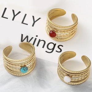 Detail of bohemian gold-plated multi-layer open ring with red agate and turquoise beads